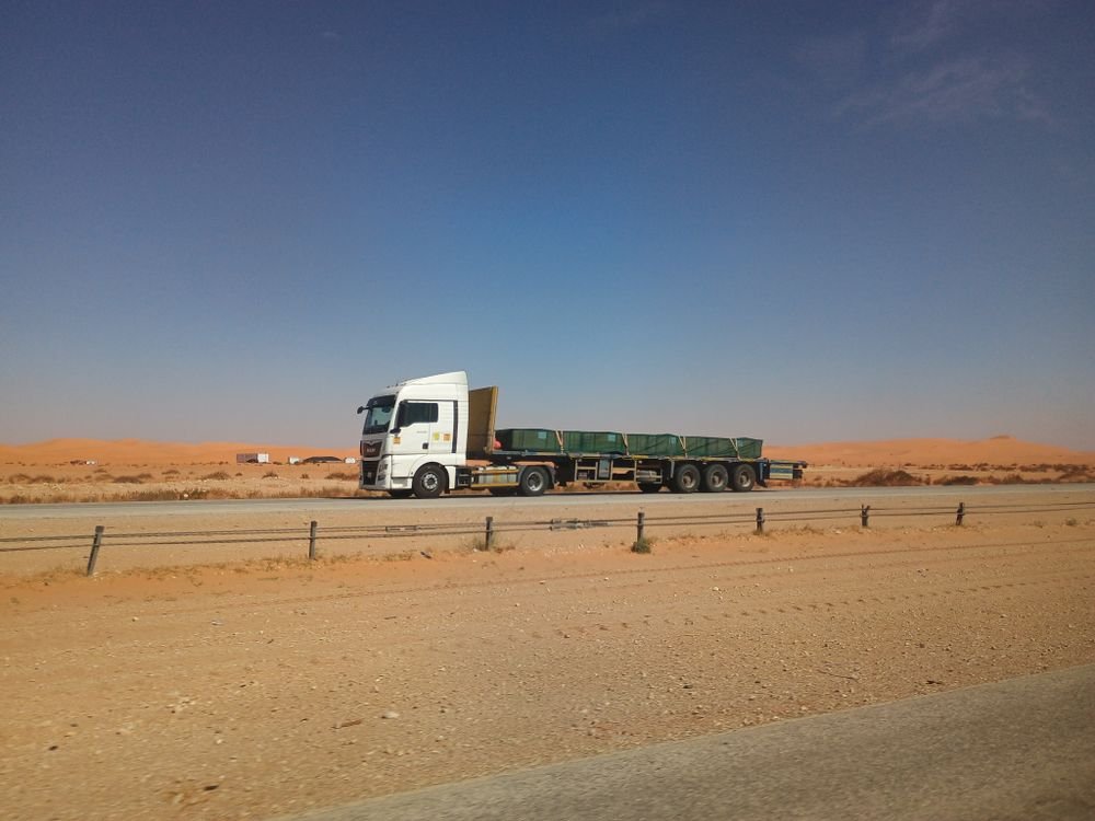Open-deck freight truck in transit